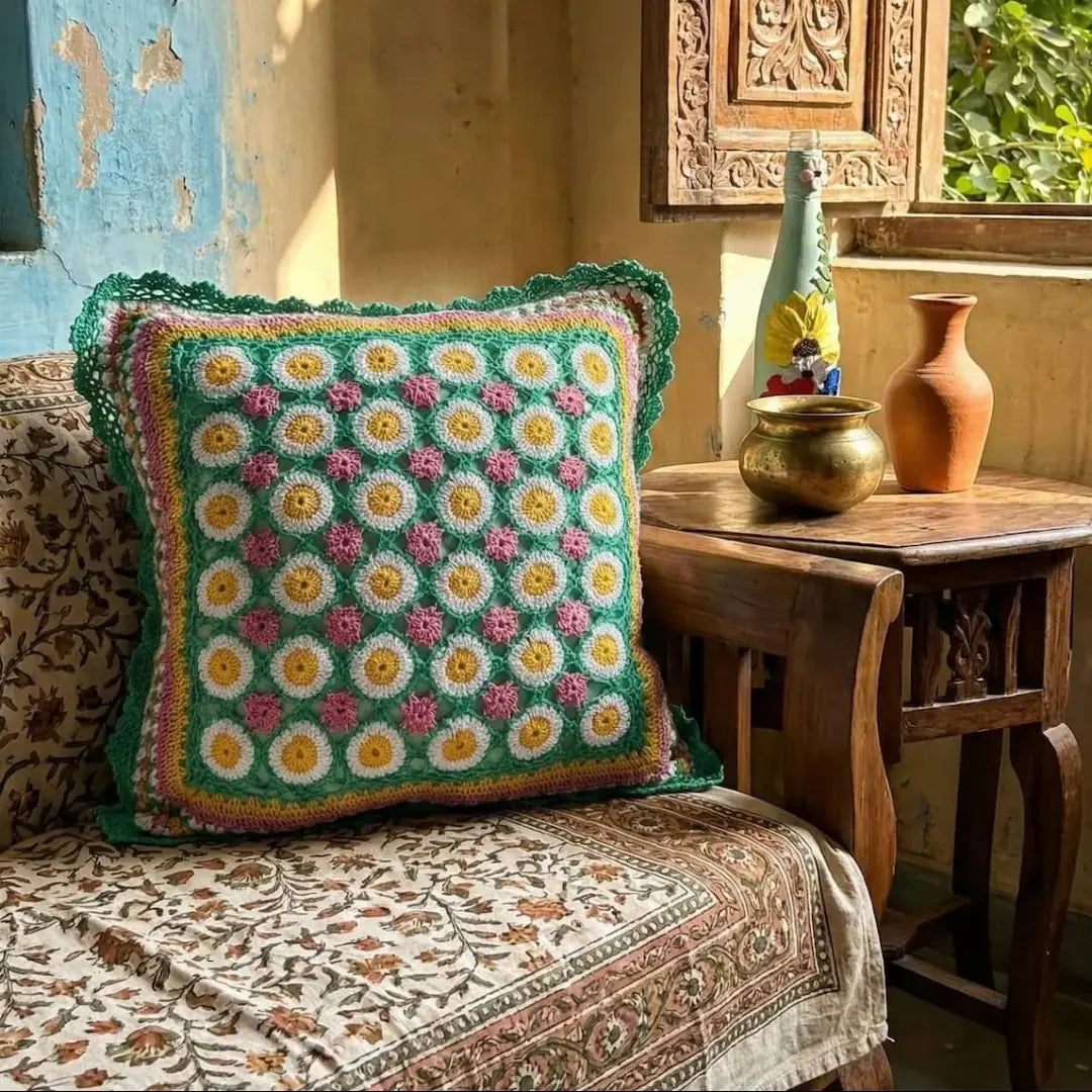 Decorative pillow with floral pattern on a patterned chair in a home setting